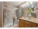 Bathroom features a glass door shower with a built-in bench and a granite counter vanity at 6595 Meade Ct, Arvada, CO 80003