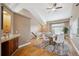 Stylish dining room with hardwood floors, bar, and natural light at 6595 Meade Ct, Arvada, CO 80003