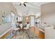 Open dining area with hardwood floors and seating for four at 6595 Meade Ct, Arvada, CO 80003