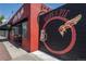 Hops & Pie retail storefront featuring custom wall art, red brick facade, and an awning at 6595 Meade Ct, Arvada, CO 80003