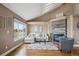 Bright living room features a fireplace, large window, and vaulted ceilings for a spacious feel at 6595 Meade Ct, Arvada, CO 80003