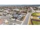 Aerial view of a well-maintained neighborhood with tree-lined streets near a baseball field at 6595 Meade Ct, Arvada, CO 80003