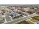 Aerial view of a well-maintained neighborhood with tree-lined streets near a baseball field at 6595 Meade Ct, Arvada, CO 80003