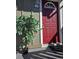 Inviting red front door with decorative window and artificial tree, with address number G-208 at 857 S Van Gordon Ct # G208, Lakewood, CO 80228