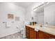 Well-lit bathroom features a sink, and a decorative mirror with vanity lighting at 5726 N Genoa Way # 204, Aurora, CO 80019