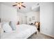 Light-filled bedroom with a ceiling fan, chair, and plush carpet at 5726 N Genoa Way # 204, Aurora, CO 80019