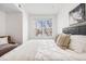 Comfortable bedroom with a large window and a cozy reading chair at 5726 N Genoa Way # 204, Aurora, CO 80019