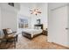 Bright bedroom features a ceiling fan, a window, and a comfortable seating area at 5726 N Genoa Way # 204, Aurora, CO 80019