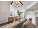 Bright dining room with wood table, neutral chairs, and decorative light fixture at 5726 N Genoa Way # 204, Aurora, CO 80019