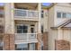 Exterior view showing balconies on a brick and siding condominium building at 5726 N Genoa Way # 204, Aurora, CO 80019