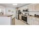 Kitchen area with stainless steel appliances and light wood cabinets at 5726 N Genoa Way # 204, Aurora, CO 80019