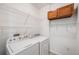 Laundry room with washer, dryer, and wire shelving at 5726 N Genoa Way # 204, Aurora, CO 80019