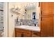 Stylish bathroom vanity featuring decorative tile backsplash and ample storage at 2325 S Linden Ct # 101, Denver, CO 80222