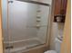 Bathroom featuring a bathtub and shower with glass doors at 2325 S Linden Ct # 101, Denver, CO 80222