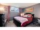 Comfortable bedroom with a black bed frame, and large window at 2325 S Linden Ct # 101, Denver, CO 80222