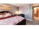 Cozy bedroom with comfortable bed, pillows, and a view into the bathroom at 2325 S Linden Ct # 101, Denver, CO 80222