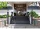 Front entrance of building with steps leading to glass doors and signage at 2325 S Linden Ct # 101, Denver, CO 80222