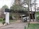 Welcoming driveway and covered entrance, surrounded by mature trees and lush landscaping at 2325 S Linden Ct # 101, Denver, CO 80222