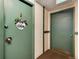 Apartment entrance with welcome sign and dual green doors at 2325 S Linden Ct # 101, Denver, CO 80222