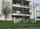 Apartment building featuring balconies and secure gated patio on the ground floor at 2325 S Linden Ct # 101, Denver, CO 80222