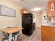 Kitchen with dining area and black appliances and ample cabinet space at 2325 S Linden Ct # 101, Denver, CO 80222