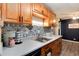 Well-lit kitchen with modern countertops, wooden cabinets, and decorative backsplash at 2325 S Linden Ct # 101, Denver, CO 80222