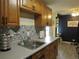 Kitchen featuring decorative backsplash, white countertops, and wooden cabinets at 2325 S Linden Ct # 101, Denver, CO 80222