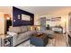Comfortable living room with a gray sectional, a stylish accent wall, and tasteful decor at 2325 S Linden Ct # 101, Denver, CO 80222