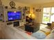 Comfortable living room with a fireplace, TV, and sliding glass doors to the outside at 2325 S Linden Ct # 101, Denver, CO 80222