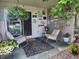 Charming patio featuring rocking chairs, flower baskets, and decorative wall art at 2325 S Linden Ct # 101, Denver, CO 80222