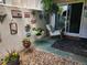 Charming patio area with decorative wall hangings, flower planters, and a comfortable rocking chair at 2325 S Linden Ct # 101, Denver, CO 80222