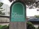 Community sign for Atrium Condominiums in a lush, green neighborhood at 2325 S Linden Ct # 101, Denver, CO 80222