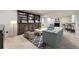 A finished basement with a seating area, custom built-in shelves, and a wet bar at 3310 S Oneida Way, Denver, CO 80224