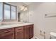 Bathroom with a dark wood vanity, granite countertop, tile flooring and shower at 3310 S Oneida Way, Denver, CO 80224