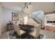 Classic dining room with a dark wood table, neutral colored chairs and contemporary lighting at 3310 S Oneida Way, Denver, CO 80224