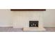 Close up view of a modern fireplace with a light marble surround and dark wood mantle at 3310 S Oneida Way, Denver, CO 80224