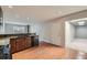 Kitchen with wooden cabinets, granite counters and open layout to living area at 3310 S Oneida Way, Denver, CO 80224