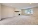 Large, open living room with carpet, neutral walls, fireplace and a large window at 3310 S Oneida Way, Denver, CO 80224