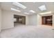 Spacious living room with skylights, neutral carpet and fresh paint at 3310 S Oneida Way, Denver, CO 80224