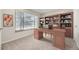 Comfortable office space featuring built-in bookshelves and a large desk at 3310 S Oneida Way, Denver, CO 80224