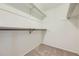 Walk-in closet featuring carpeted floor and shelves with hanging rods at 3310 S Oneida Way, Denver, CO 80224