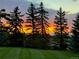 Backyard view featuring manicured lawn and vibrant sunset at 2408 Concord Cir, Lafayette, CO 80026