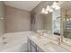 Bright bathroom featuring double sinks, modern lighting, and a bathtub at 2408 Concord Cir, Lafayette, CO 80026