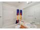 Neat bathroom with a shower-tub combo, a neutral vanity, and a large mirror at 2408 Concord Cir, Lafayette, CO 80026
