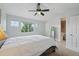 Bright bedroom with natural light, a ceiling fan, and an ensuite bathroom at 2408 Concord Cir, Lafayette, CO 80026