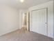 Comfortable bedroom with neutral carpeting, a double door closet, and bright, white trim at 2408 Concord Cir, Lafayette, CO 80026
