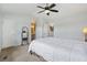 Spacious bedroom with carpet, ceiling fan, ensuite bathroom, and a decor mirror at 2408 Concord Cir, Lafayette, CO 80026