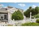 Charming exterior view of home with a white picket fence and lush greenery at 2408 Concord Cir, Lafayette, CO 80026