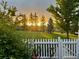 Well-manicured lawn and charming white picket fence at sunset at 2408 Concord Cir, Lafayette, CO 80026
