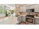 Sunlit kitchen with stainless appliances, light countertops, and a seamless flow to living area at 2408 Concord Cir, Lafayette, CO 80026